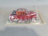 a red toy car sitting on a clear tray
