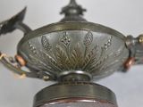 a silver vase with a flower design on it