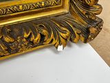 an image of a picture of a gold frame with writing on it