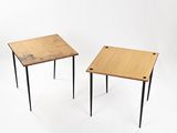 two small wooden tables with black legs on a white background