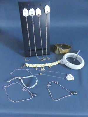 several pieces of jewelry sitting on a table with a blue background