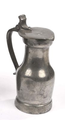 a silver pitcher with a lid on a white background