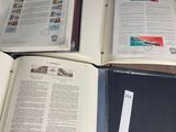 three open books sitting on top of a black table next to each other