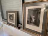 two framed pictures on the wall above a toilet
