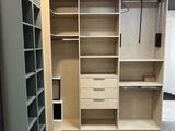 an image of a walk - in closet with shelves and drawers