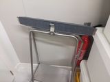 a metal shelf with a fire extinguisor attached to it