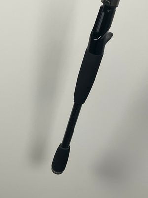 a black umbrella with a black handle hanging from it ' s side