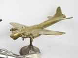 a silver statue of a plane and a silver statue of a hand