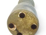 a metal object with holes on it on a white surface