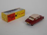 a small toy car next to a box on a white surface
