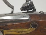 an old gun with a brass handle on a white background