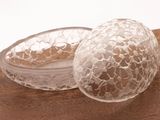 a glass egg sitting on top of a wooden table