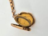 a gold locke with a chain around it on a white surface