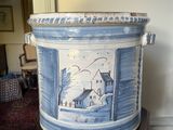 un grand vase bleu et blanc posé sur un socle en bois