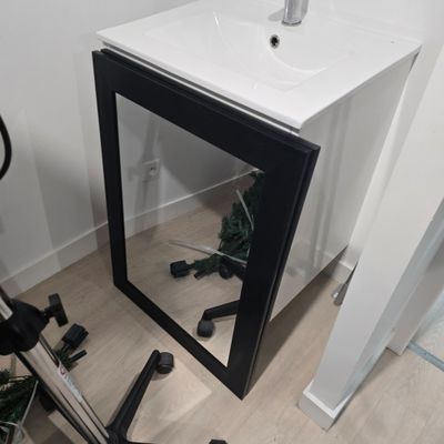 a mirror on the wall next to a bike in a room