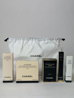chanel makeup set in a white bag with a black handle