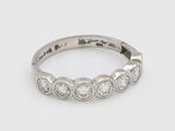 a close up of a diamond ring on a white background