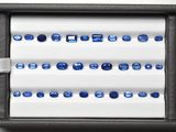 a display of blue sapphires in a black box