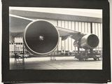 a black and white photo of an airplane being worked on
