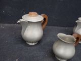 two white vases sitting next to each other on the floor