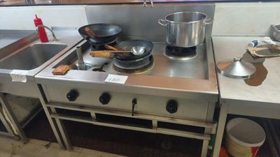 a stove with pots and pans on it in a kitchen