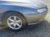 a close up of a car tire on a gravel road