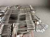 a lot of silver spoons and forks on the table