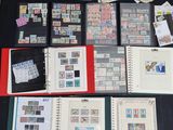 a lot of stamps on a table with a binder on it