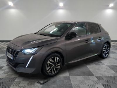 the grey car is parked on a checkered floor in a garage