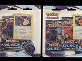two packs of pokemon trading cards on a black background