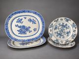 two blue and white plates with floral designs on them