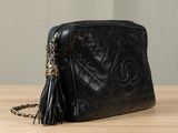 chanel black quilted leather cross body bag with tassel