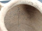 a vase with a crack in it sitting on a table