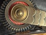 a close up of a leather hat with a metal buckle on it
