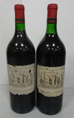 two bottles of wine sitting on top of a table next to each other