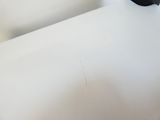 a black bird sitting on a white table