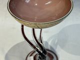 a small table with a glass bowl on top of it