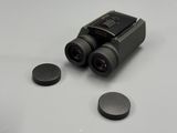 a pair of binoculars sitting on a table next to a pair of magnets