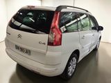 the rear of a white citrole is parked in a garage