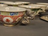 a lot of bowls and cups on the table