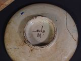 a white plate with a writing on it sitting on a table