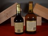 two bottles of wine sitting next to each other on a table