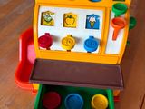 a toy cash register on a wooden table