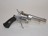 an old revolver with a wooden handle on a white surface