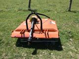 a small orange machine that is sitting in the grass