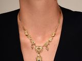 a woman wearing a black shirt and a gold necklace