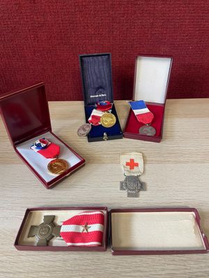 several medals and medals are sitting on a wooden table