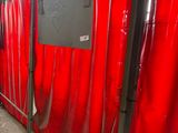 a room with a red curtain and a tv on the wall