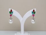 pair of multicolored crystal and pearl earrings on a white stand
