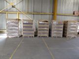 several stacks of boxes of assorted items in a warehouse